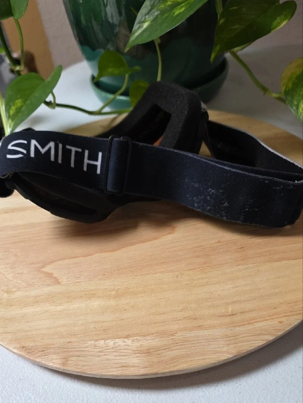 Smith Optics snow goggles featuring a black strap with white branding